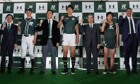 新ユニホームを身にまとった野球、ラグビー、陸上部の主将と関東学院の増田日出雄理事長（右から３人目）、ドームの安田秀一ＣＥＯ（同５人目）＝横浜市で４月