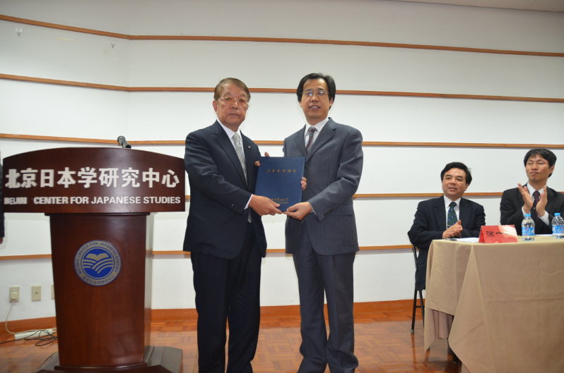 北京外国語大の孫有中副学長(右)から名誉教授の称号を受ける大平裕理事長