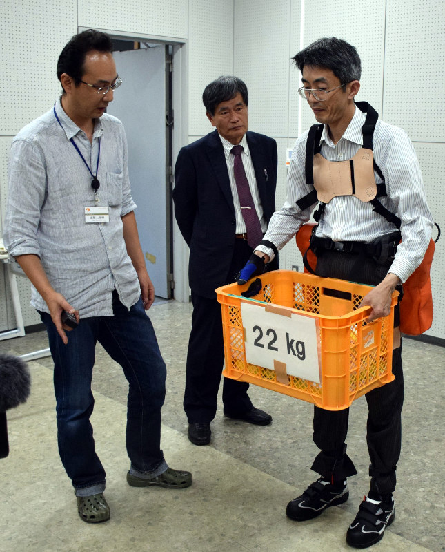 農業用パワーアシストスーツを開発中の八木特任教授(中央)らのグループ=和歌山市栄谷の和歌山大で、谷田朋美撮影
