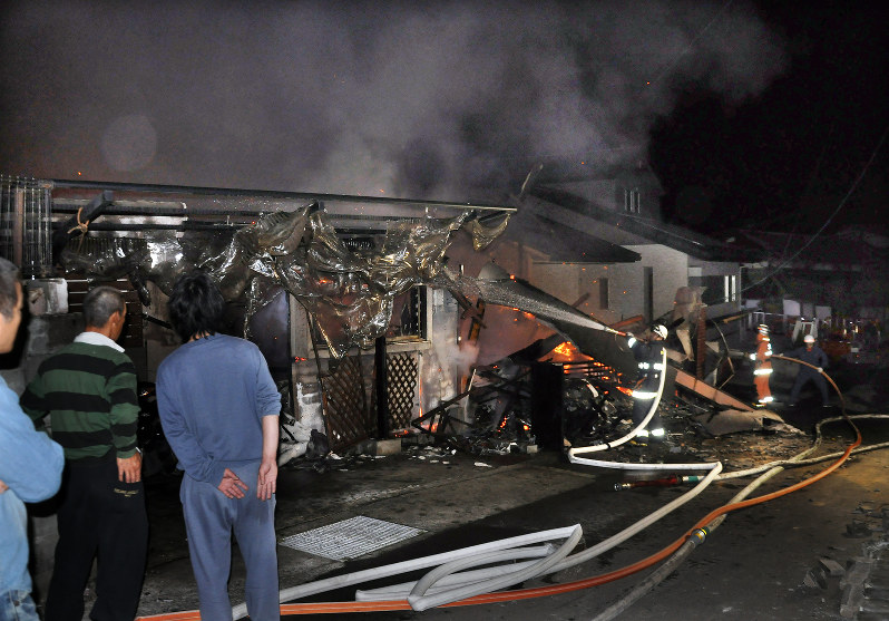 地震のため倒壊し、火事になった民家=熊本県益城町で2016年4月14日午後10時53分、野呂賢治撮影