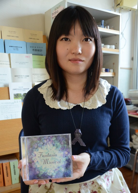 線維筋痛症の痛みを歌った「pain」の入ったアルバムを持つ如月まぁやさん=東京都武蔵野市で2016年5月19日、蒔田備憲撮影