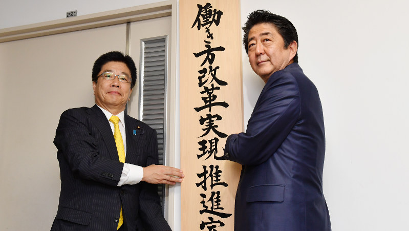 「働き方改革実現推進室」の看板をかける安倍首相と加藤働き方改革相=2016年9月2日、代表撮影