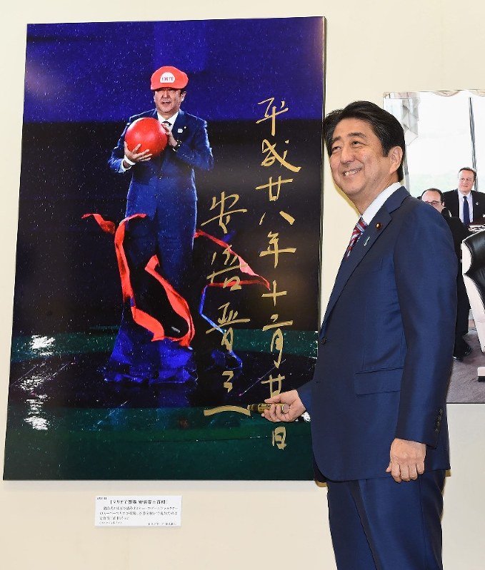 安倍首相：「報道写真展」を鑑賞 「マリオ」サイン | 毎日新聞