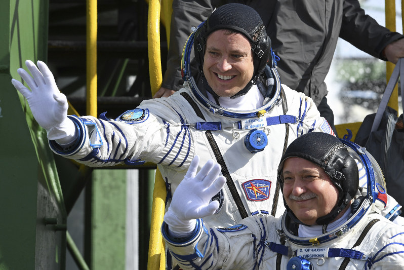 Soyuz space capsule carrying American, Russian blasts off
