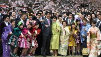 「桜を見る会」で招待者に囲まれ、笑顔で記念写真に納まる安倍晋三首相と妻の昭恵氏＝東京都内の新宿御苑で２０１７年４月１５日、竹内紀臣撮影