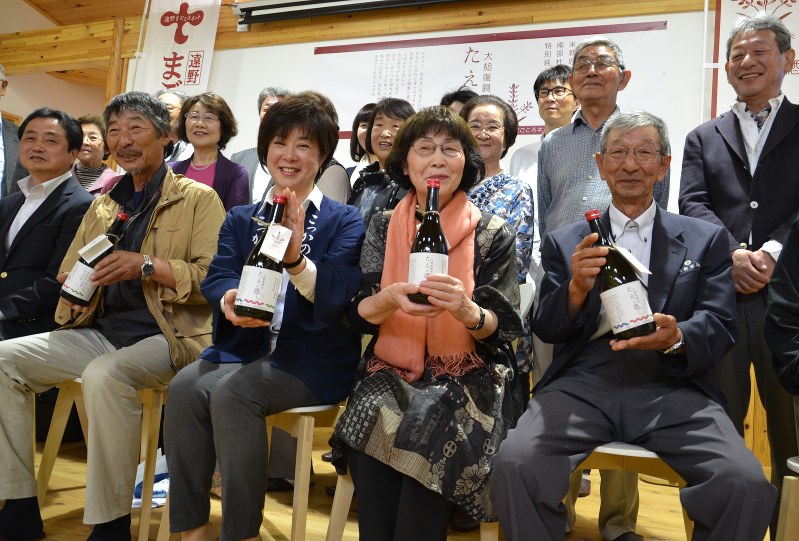 大槌復興米を使った特別純米酒「たえの酒」の誕生を喜ぶ菊池妙さん(前列右から2人目)と新里佳子さん(同3人目)ら=大槌町で
