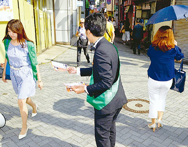 街頭でチラシを配布しながら支持を訴える、都議選立候補予定者=東京都北区で20日、渡部直樹撮影(画像の一部を加工しています)