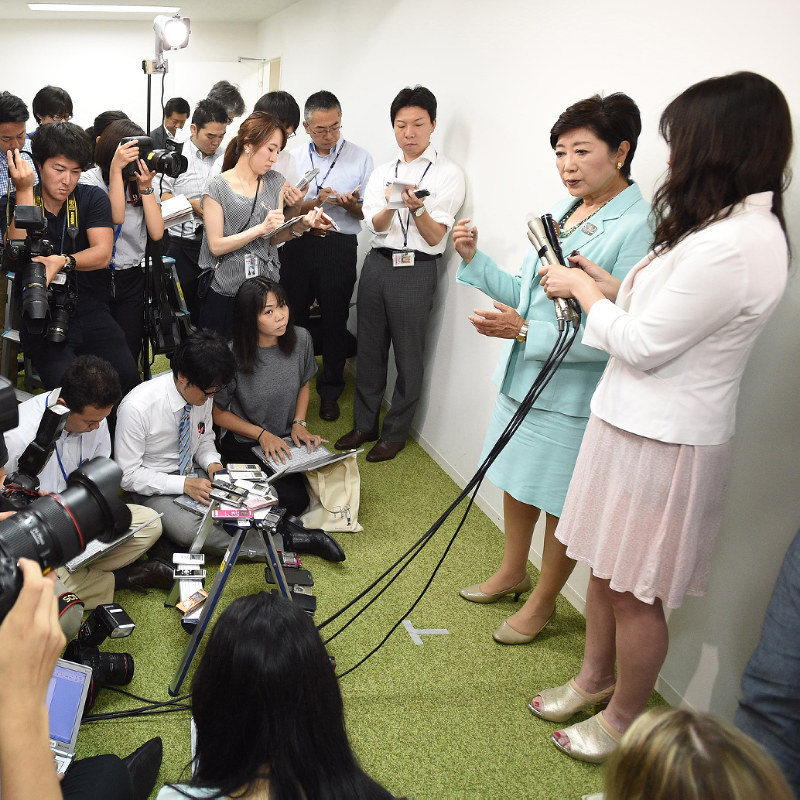 都議選投開票から一夜明け、大勢の報道陣に囲まれる小池百合子知事(右から2人目)=東京都新宿区で3日、丸山博撮影