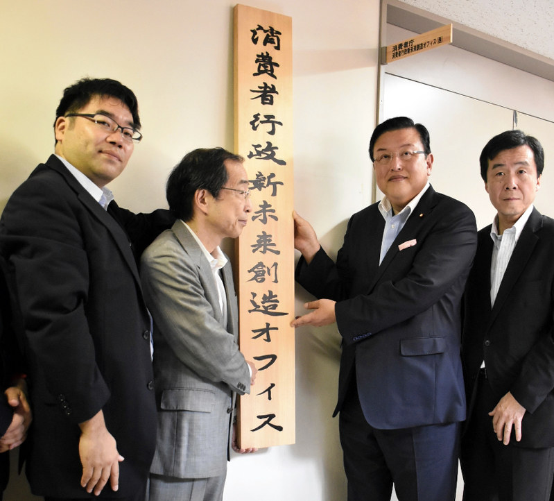 「消費者行政新未来創造オフィス」の看板を掛ける長坂康正・内閣府政務官(右から2番目)ら=徳島市万代町1の徳島県庁10階で2017年7月24日、松山文音撮影