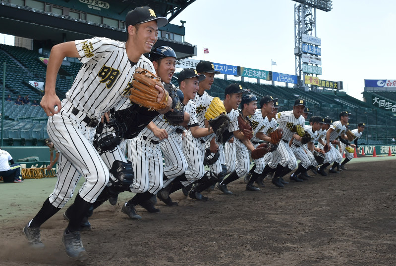 グラウンドに飛び出す明桜の選手たち=阪神甲子園球場で、三浦博之撮影