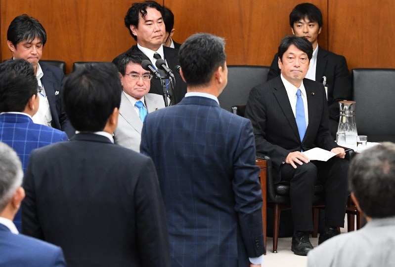 衆院安全保障委員会で北朝鮮の弾道ミサイル発射に抗議する決議案の採決で賛成のため起立する議員たちを見る小野寺五典防衛相(奥前列右)と河野太郎外相(同左)=国会内で2017年8月30日午後2時半、川田雅浩撮影