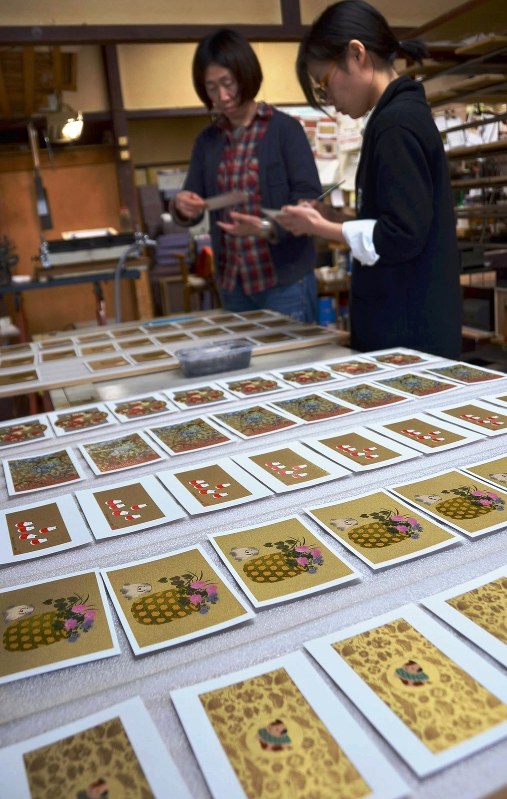 色鮮やかな蒔絵年賀状。重ね塗りした図柄に金粉をまぶして仕上げられていた=会津若松市馬場町の関漆器店工房で