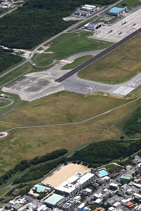 普天間第二小学校(手前)。奥は米軍普天間飛行場=7月23日、本社機から矢頭智剛撮影
