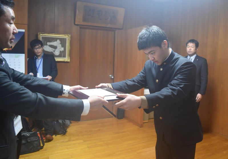 県高野連の牟田久俊会長(左)から表彰盾を受け取る占部さん