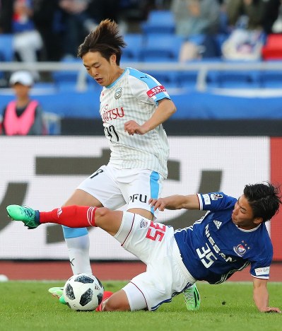 【横浜マ－川崎】後半、横浜マの吉尾（下）のスライディングでドリブル突破を阻まれる川崎の斎藤＝日産スタジアムで２０１８年４月８日、長谷川直亮撮影