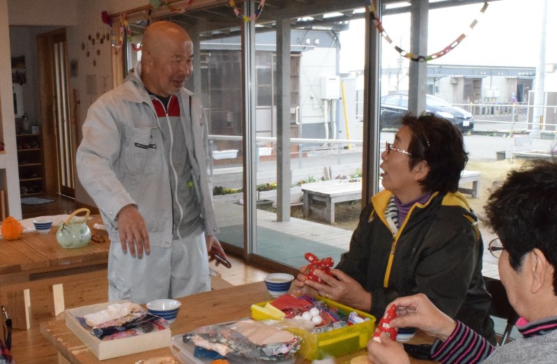 木山仮設団地の集会所で手芸サークルに集う女性たちと談笑する荒瀬さん(左)=熊本県益城町で、福岡賢正撮影