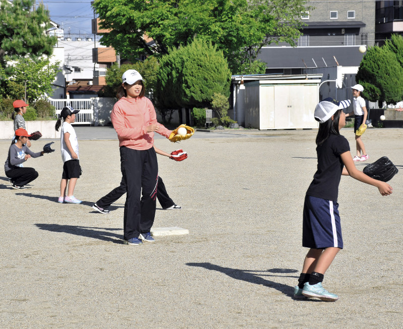 教員の指導を受けキャッチボールするソフトボール部の児童たち=名古屋市中村区の日比津小学校で、太田敦子撮影