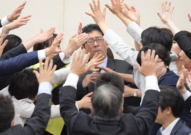 衆院厚生労働委員会での働き方改革関連法案の採決で、野党の議員たちに詰め寄られる高鳥修一委員長(中央)=国会内で5月25日、川田雅浩撮影