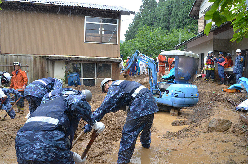 男性捜索のため、自宅敷地に流れ込んだ大量の土砂を取り除く海上自衛隊員や消防隊員ら=京都府舞鶴市城屋で2018年7月7日午前11時16分、鈴木健太郎撮影