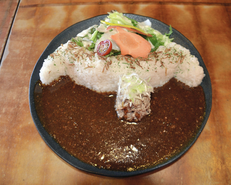 ダムのえん堤に見立てたライスでしっかりとルーをせき止めた「豚のさんぽ」の黒部ダムカレー=長野県大町市で2018年6月4日午後2時51分、安元久美子撮影