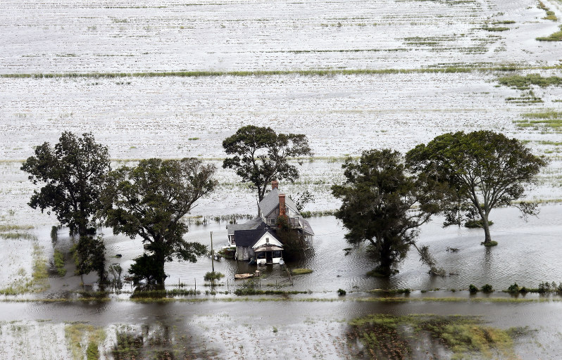 A farm house is surrounded by flooded fields from tropical storm Florence in Hyde County N.C. Saturday Sept. 15 2018