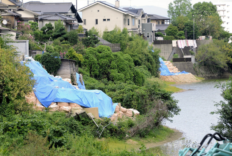 豪雨で擁壁が崩れた源蔵池沿いの住宅。住民側は再発防止のため護岸整備を要望している=福岡市南区桧原で、宮原健太撮影