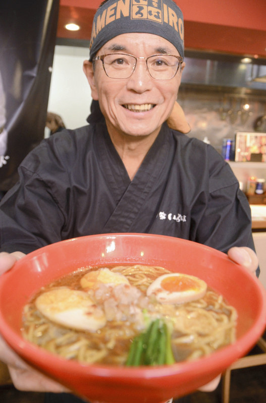 「ハラルラーメン」を持つ従業員=富山市で2018年10月17日午後2時26分、鶴見泰寿撮影