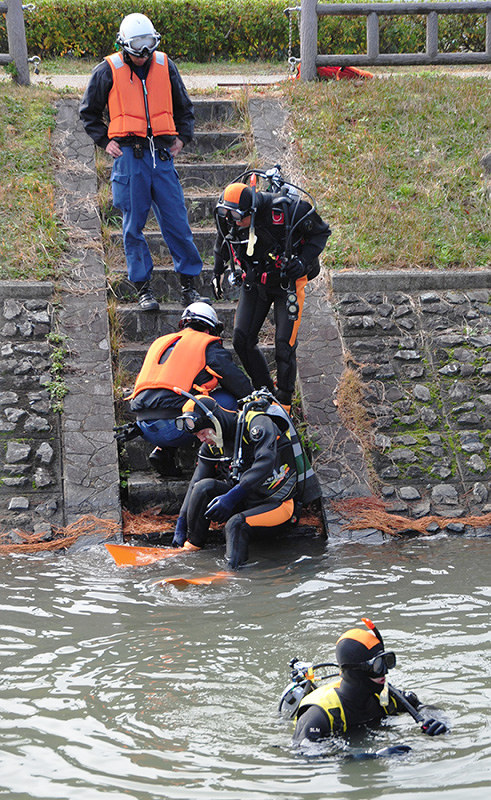 水中検索の訓練に向かう京都・福知山市消防本部の水難救助隊員たち=同市猪崎の三段池で、佐藤孝治撮影
