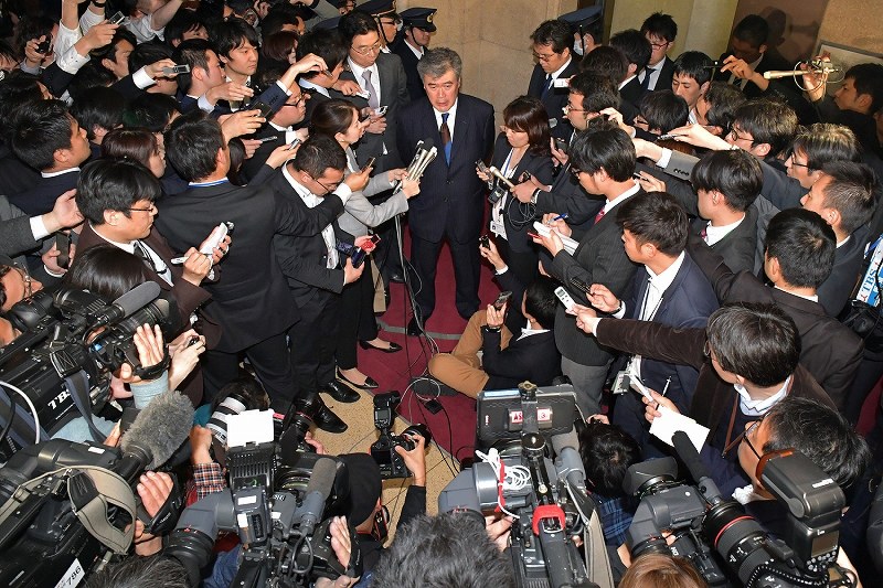 大勢の報道陣の前で辞任を表明し、質問に答える財務省の福田淳一事務次官（中央）＝東京都千代田区で２０１８年４月１８日午後６時５５分、渡部直樹撮影