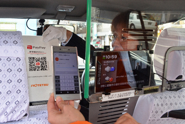 ペイペイのQRコードを示すタクシーの運転手(松山市)
