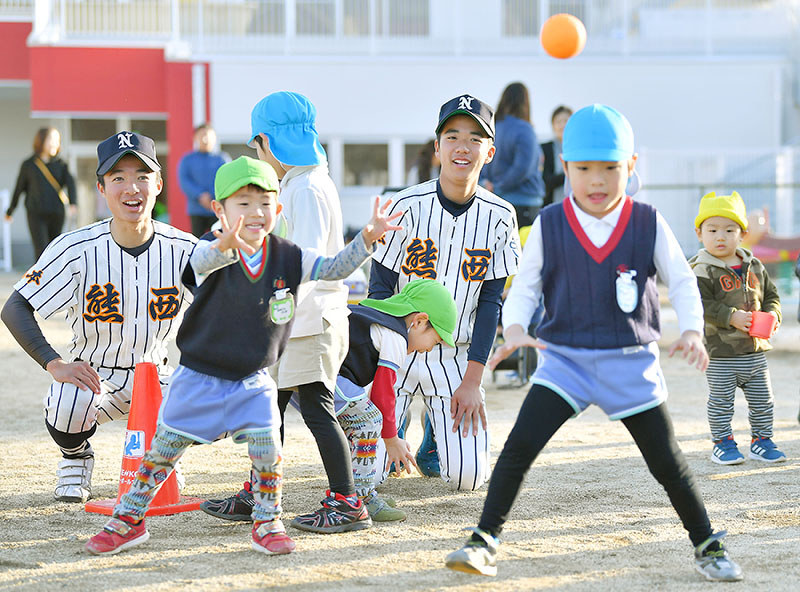 近くのこども園でティーボール体験会を開き、園児たちと交流する熊本西の選手たち=熊本市西区で2019年2月4日、徳野仁子撮影