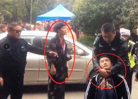 和服のような服装で武漢大の警備員に入校を阻止された男性(中央)とその友人(右下)=中国のブログ「微博」から