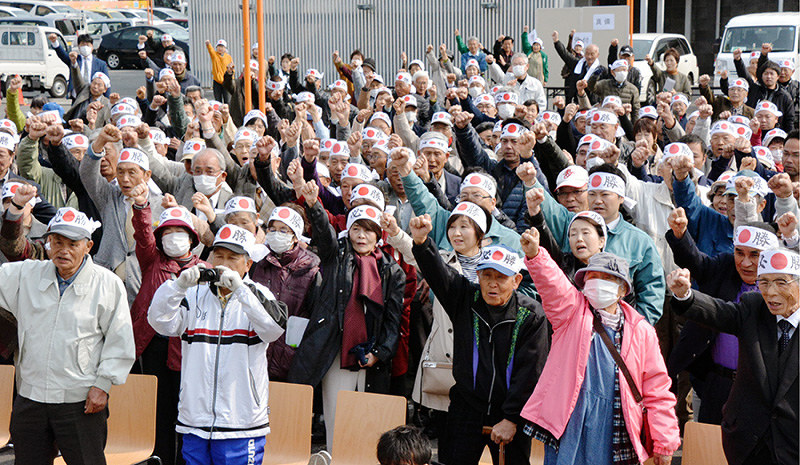 立候補者の出陣式で、掛け声に合わせて拳を挙げる支援者ら=岡山県倉敷市で、高橋祐貴撮影