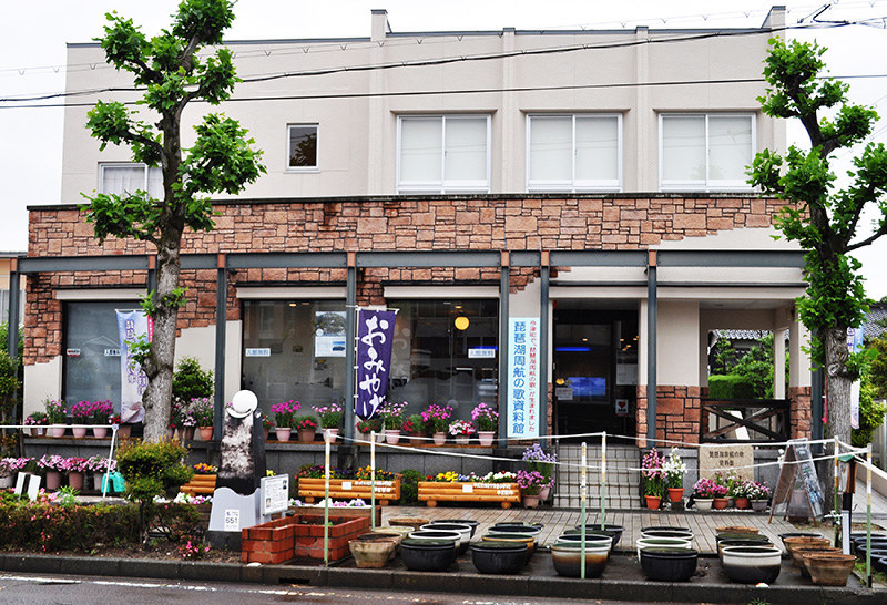 花々で彩られた琵琶湖周航の歌資料館。手前は歌の原曲ゆかりのヒツジグサの水鉢=滋賀県高島市今津町で、塚原和俊撮影