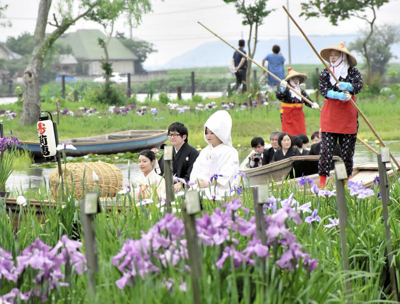 さっぱ舟に乗って園内を回る新郎新婦=千葉県香取市で