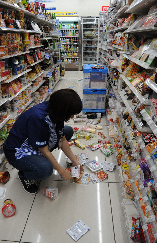 強い揺れで落ちた商品を片付けるコンビニエンスストアの店員=山形県鶴岡市若葉町で2019年6月18日午後10時40分ごろ、長南里香撮影