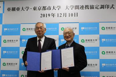 協定書を手にする東京都市大の三木千寿学長（左）と亜細亜大の大島正克学長