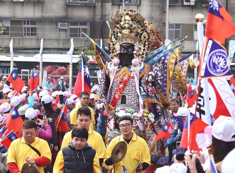 太鼓や銅鑼を鳴らす男衆に先導されて台湾の神様「七爺八爺」が登場し、選挙集会は熱気を帯びた=台北市で2019年12月28日、福岡静哉撮影
