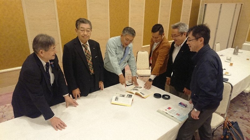40年前に始まった台湾・基隆市との交流の記録を前に、笑顔で当時を振り返る八代南ロータリークラブのメンバーたち