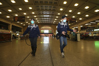 Workers spray disinfectant at a train station in Wuhan in southern China's Hubei province, on Jan. 22, 2020. (Chinatopix via AP)