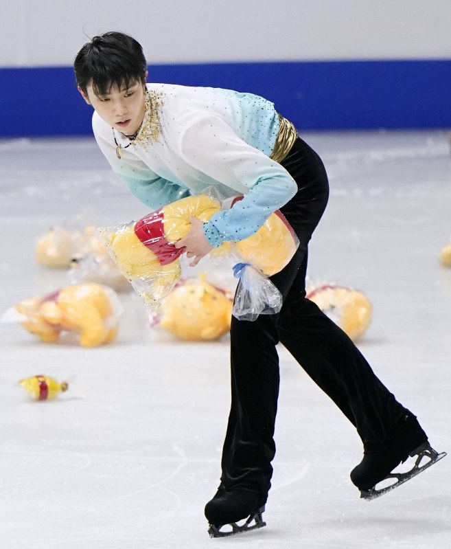 【四大陸フィギュア】男子SP演技後に、リンクに投げ入れられたぬいぐるみを拾う羽生結弦=共同