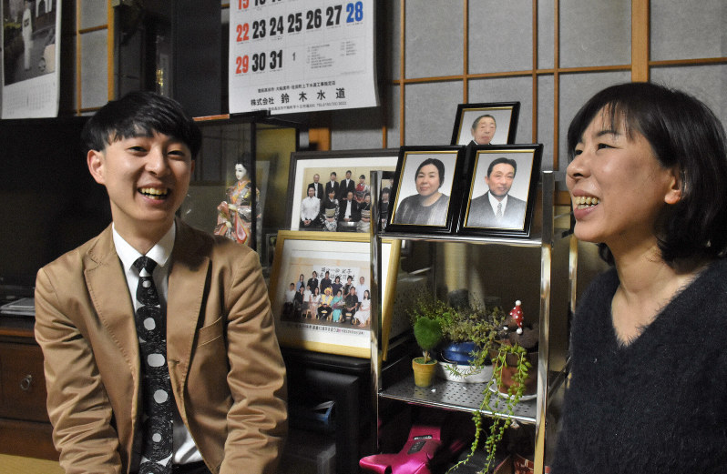 丹野晋太郎さん(左)と叔母の坂口幸嘉子さん。両親と祖母の遺影が見守る=岩手県陸前高田市竹駒町で3日、小鍜治孝志撮影