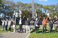 Citizen's group members form a human chain in front of the hypocenter cenotaph during an event to pray for the restoration of Fukushima, hit by the 2011 meltdowns of the Fukushima Daiichi Nuclear Power Station, at the Hypocenter Park in the city of Nagasaki, on March 11, 2020. (Mainichi/In Tanaka)