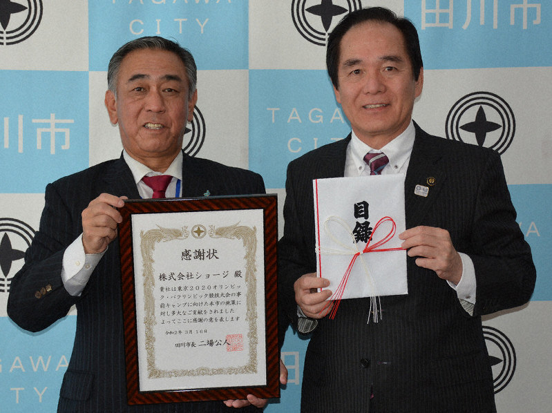 二場市長(右)に寄付の目録を手渡し、感謝状を受け取った株式会社ショージの中園社長