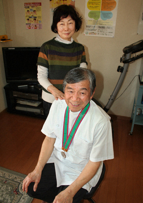 1964年東京大会のメダルを首に掛け「伴走なしで走ります」と話す岩崎博さん(手前)と妻敏子さん=熊本県八代市の自宅で2020年3月6日午後2時38分、山本泰久撮影