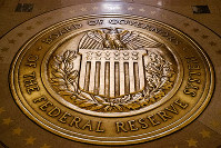 In this Feb. 5, 2018, file photo, the seal of the Board of Governors of the U.S, Federal Reserve System lies embedded in the floor at the Marriner S. Eccles Federal Reserve Board Building in Washington. (AP Photo/Andrew Harnik)