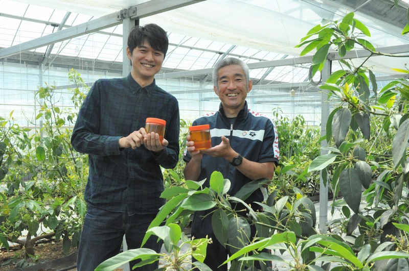 アボカド蜂蜜を手に笑顔を見せる緒方省吾さん(右)と服部学さん=宮崎市富吉の夢逢いファームで2020年4月22日午前10時38分、杣谷健太撮影
