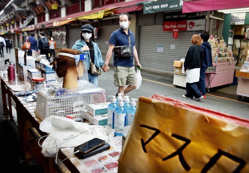 緊急事態宣言の延長が決まった日の午後、商店街で営業を続ける店ではフェースガードやマスクなどが買い物客の目を引きつけていた=東京都台東区で2020年5月4日、滝川大貴撮影
