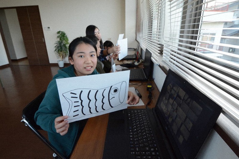 描いたこいのぼりを画面に示す参加者=新潟県南魚沼市六日町の共立観光六日町支店で