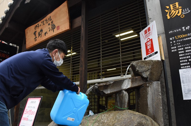 訪れた人たちはペットボトルやポリタンクを持参して源泉を持ち帰った=松山市宮田町の「伊予の湯治場 喜助の湯」で2020年5月10日午後1時6分、中川祐一撮影